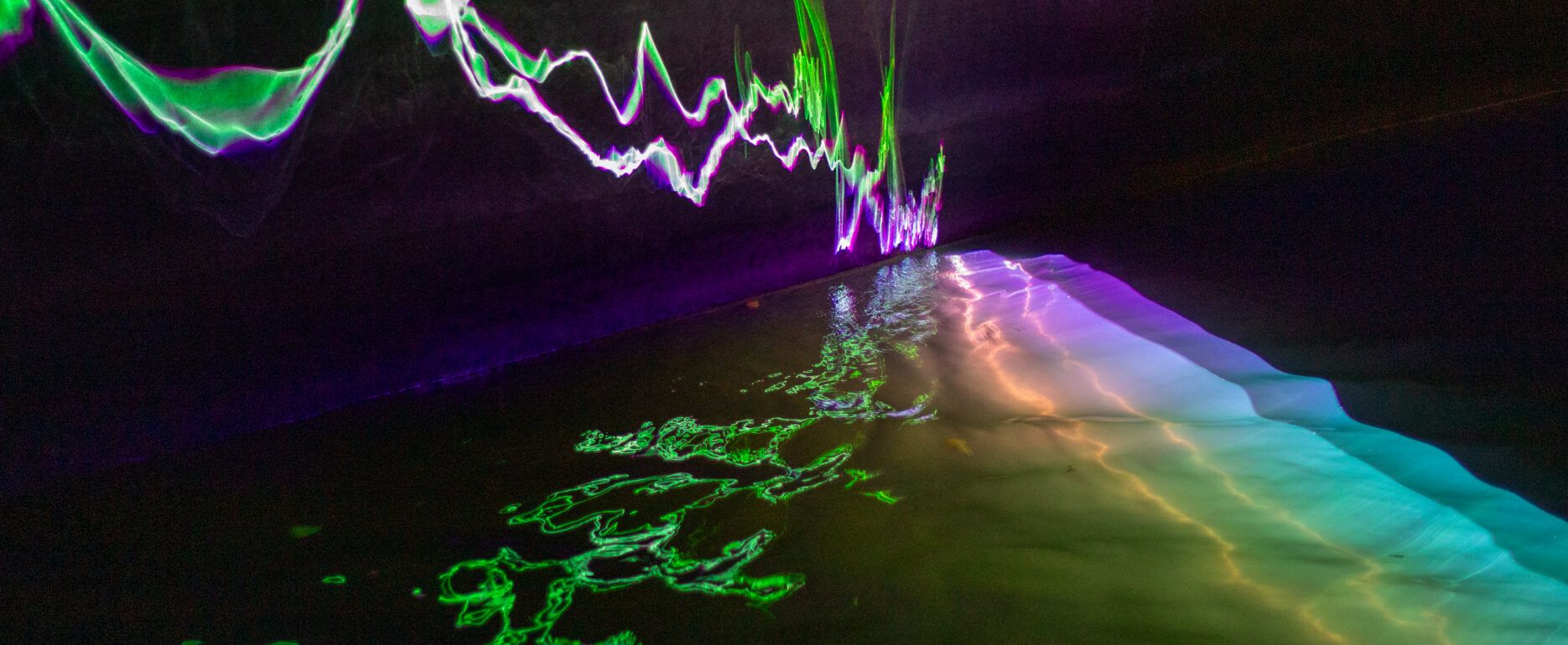 A laser projection by artist Romain Tardy reflects off the river Senne inside the Sewer Museum in Brussels