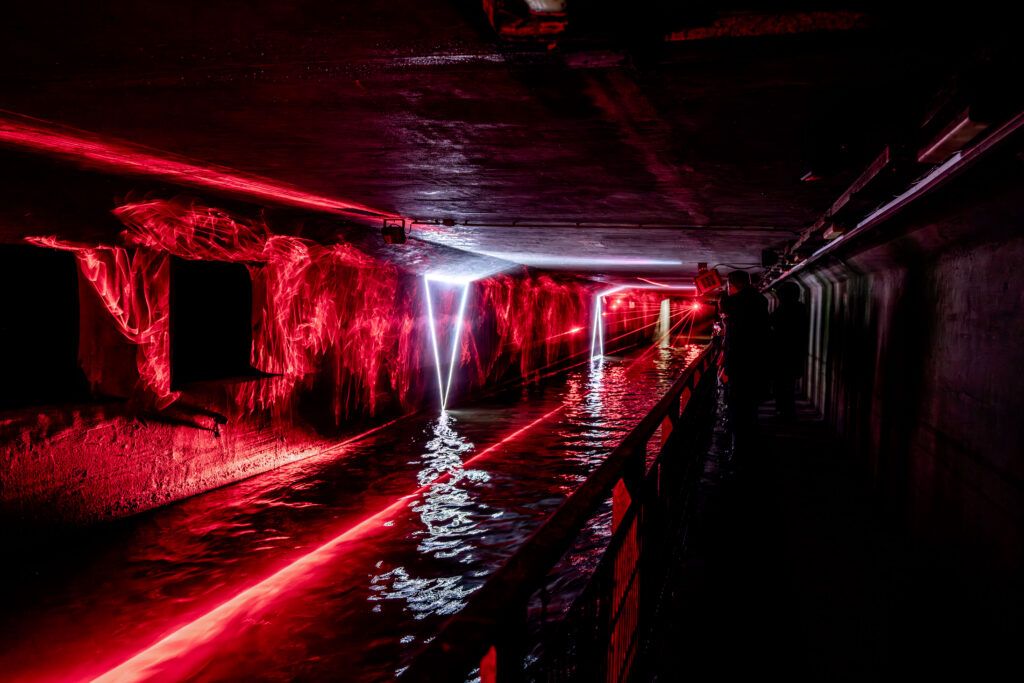 Laser beams light up the river Senne inside the Sewer Museum in Brussels